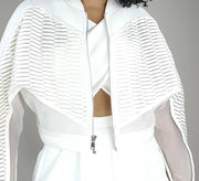 A woman wearing a Nik Spruill CONSCIOUS JACKET and skirt.