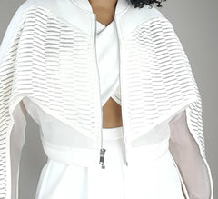 A woman wearing a Nik Spruill CONSCIOUS JACKET and skirt.