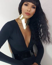 A woman with long hair wearing a black dress adorned with NANISCA - GOLD by Nik Spruill.