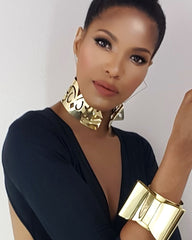 A woman in a black top is holding an ASHANTI cell phone by Nik Spruill.