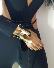 A close up of a person wearing a Nik Spruill OSHUN bracelet.