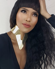 A woman with long black hair wearing a Nik Spruill NANISCA - GOLD collar.