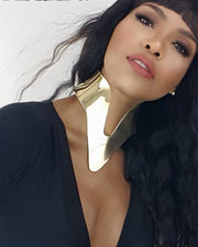 A woman wearing a NANISCA - GOLD choker and a black top by Nik Spruill.