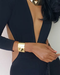 A woman wearing a Nik Spruill ISIS CUFF and a black dress.