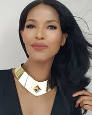 A woman with long black hair wearing a Nik Spruill ISIS gold collar.