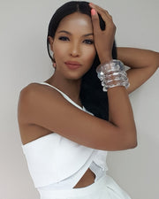 a woman in a white dress holding her hand on her head wearing ARCTIC by Nik Spruill.