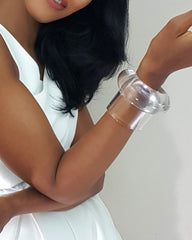 A woman in a white dress holding a Nik Spruill Bubble Set cell phone.