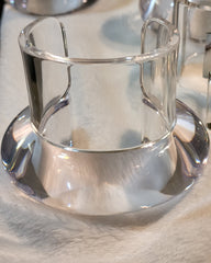 A Nik Spruill BUBBLE SET cup and saucer sitting on a table.