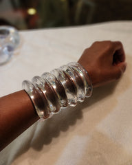 A close up of a person wearing a Nik Spruill Waves Cuff.