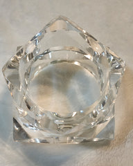A CLEAR GLASS FREEZE by Nik Spruill OBJECT SITTING ON A WHITE SURFACE.