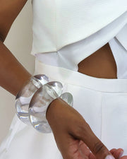 A close up of a person wearing a white dress with the Nik Spruill BUBBLE CUFF.