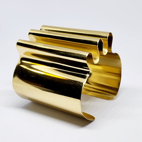 A pair of Nik Spruill CROWN cufflinks sitting on top of each other.