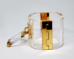 A Nik Spruill DROP - GOLD bracelet with a key attached to it.