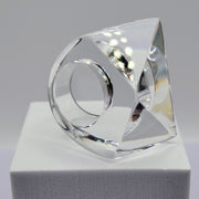 A sculpture of a YIZ ring on a white surface by Nik Spruill.