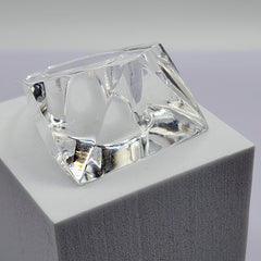A clear IMAK diamond sitting on top of a white block by Nik Spruill.