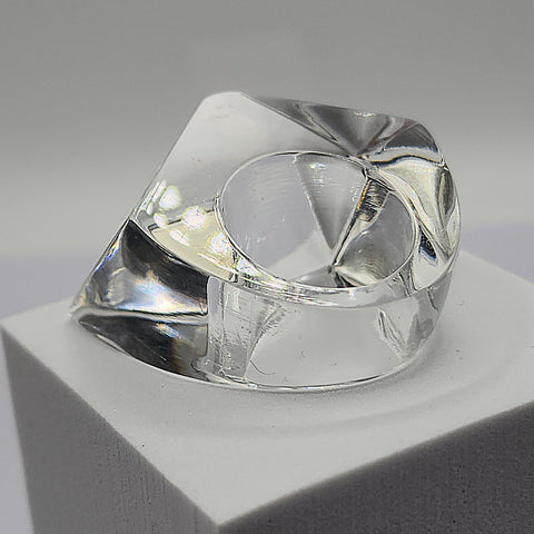A Nik Spruill ITGA ring sitting on top of a white block.