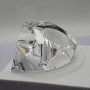 A clear IMAK ring sitting on top of a white Nik Spruill box.