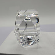 A Nik Spruill ITGA clear glass vase sitting on top of a table.