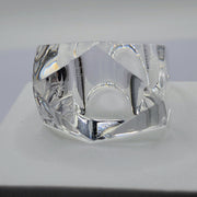A close up of a Nik Spruill YIZ glass object on a table.