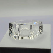 A clear ZENUS ring sitting on top of a white Nik Spruill box.