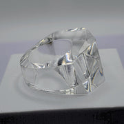 A clear ZENUS ring sitting on top of a white Nik Spruill box.