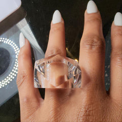 A woman's hand with a YIZ ring on it by Nik Spruill.