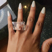 A woman's hand with a Nik Spruill IMAK diamond ring on it.