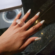 A woman's hand with white nails and a ZENUS ring by Nik Spruill.