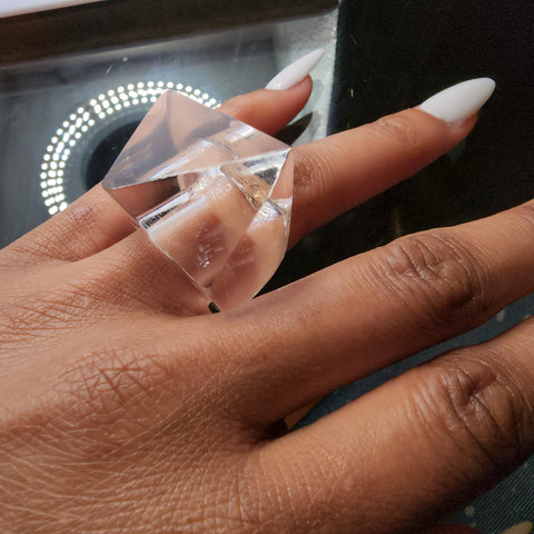 A woman's hand with an IMAK ring on it, designed by Nik Spruill.
