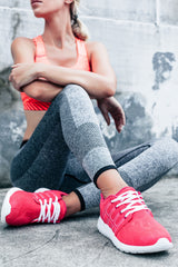 a woman sitting on the ground with her arms crossed wearing B'nand's Bullseye Legging.