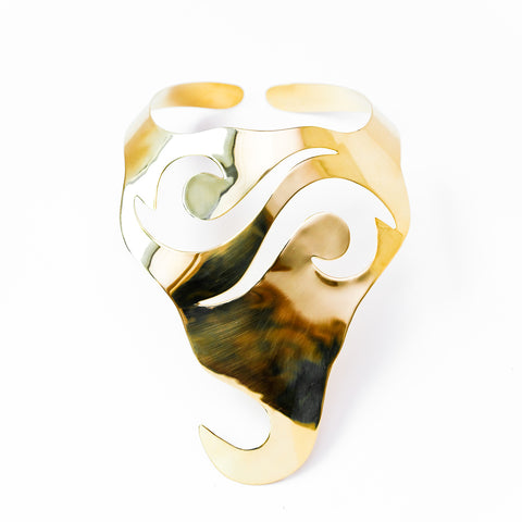 A close up of a NAWI metal object by Nik Spruill on a white surface.