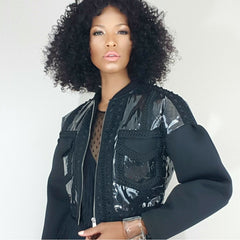 Nicole Spruill model in a black neoprene , mesh and clear vinyl bell sleeve jacket