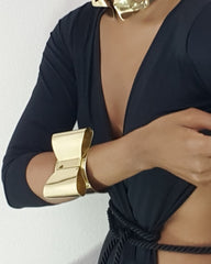 A woman wearing an ASHANTI bracelet and a black top by Nik Spruill.