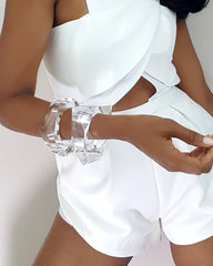 A woman wearing a white dress and a Nik Spruill GLOSS bracelet.
