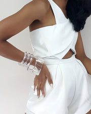 A woman in a white ICEBERG dress with her hands on her hips by Nik Spruill.