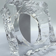 A METROPOLIS glass sculpture of a ring on a table by Nik Spruill.
