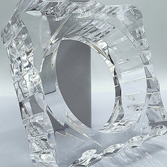 A METROPOLIS glass sculpture of a ring on a table by Nik Spruill.
