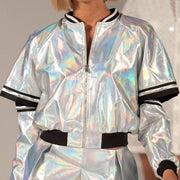 A woman wearing Nik Spruill's ILLUMINATE silver jacket and silver pants.
