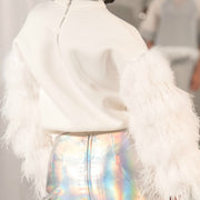 model back view in a white neoprene sweatshirt to with feather sleeves and back zipper haute couture