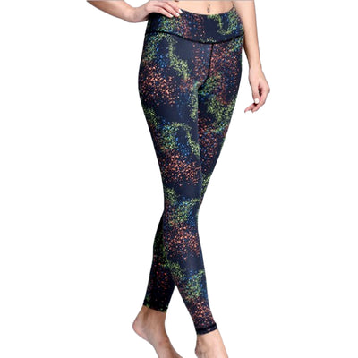 A woman in iYoga's CONSTELLATION LEGGING with a black and green pattern.
