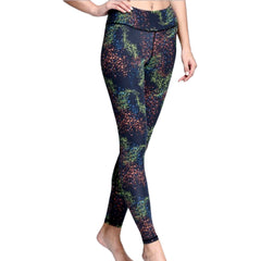 A woman in iYoga's CONSTELLATION LEGGING with a black and green pattern.