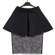 A Nik Spruill Spectator Skirt hanging on a hanger.