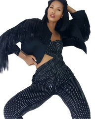 A woman in a Nik Spruill Spotlight One Shoulder Jumpsuit - Black and polka dot pants.