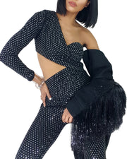 A woman posing in a Nik Spruill Spotlight One Shoulder Jumpsuit - Black outfit.