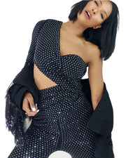 A woman in a Nik Spruill Spotlight One Shoulder Jumpsuit - Black.