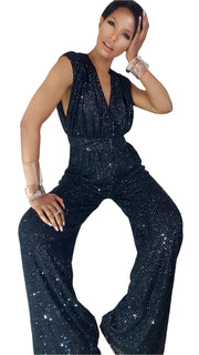 A woman in a Nik Spruill Glitz Sequined Jumpsuit - Black posing for a picture.