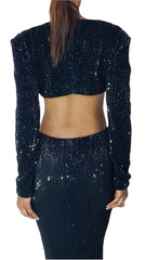 A woman wearing a Nik Spruill Aja Sequined Cut Out Dress in Black.