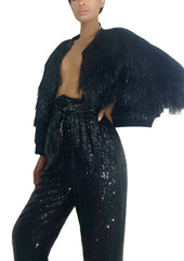 A woman in Nik Spruill's Maya relaxed fit sequined pant - black and a black jacket.