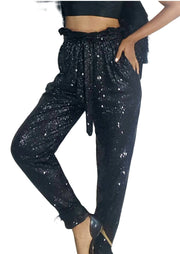 A woman in Nik Spruill's Maya relaxed fit sequined pant - black and a crop top.