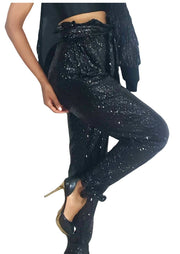 A woman wearing Maya relaxed fit sequined pants - black by Nik Spruill and a black top.